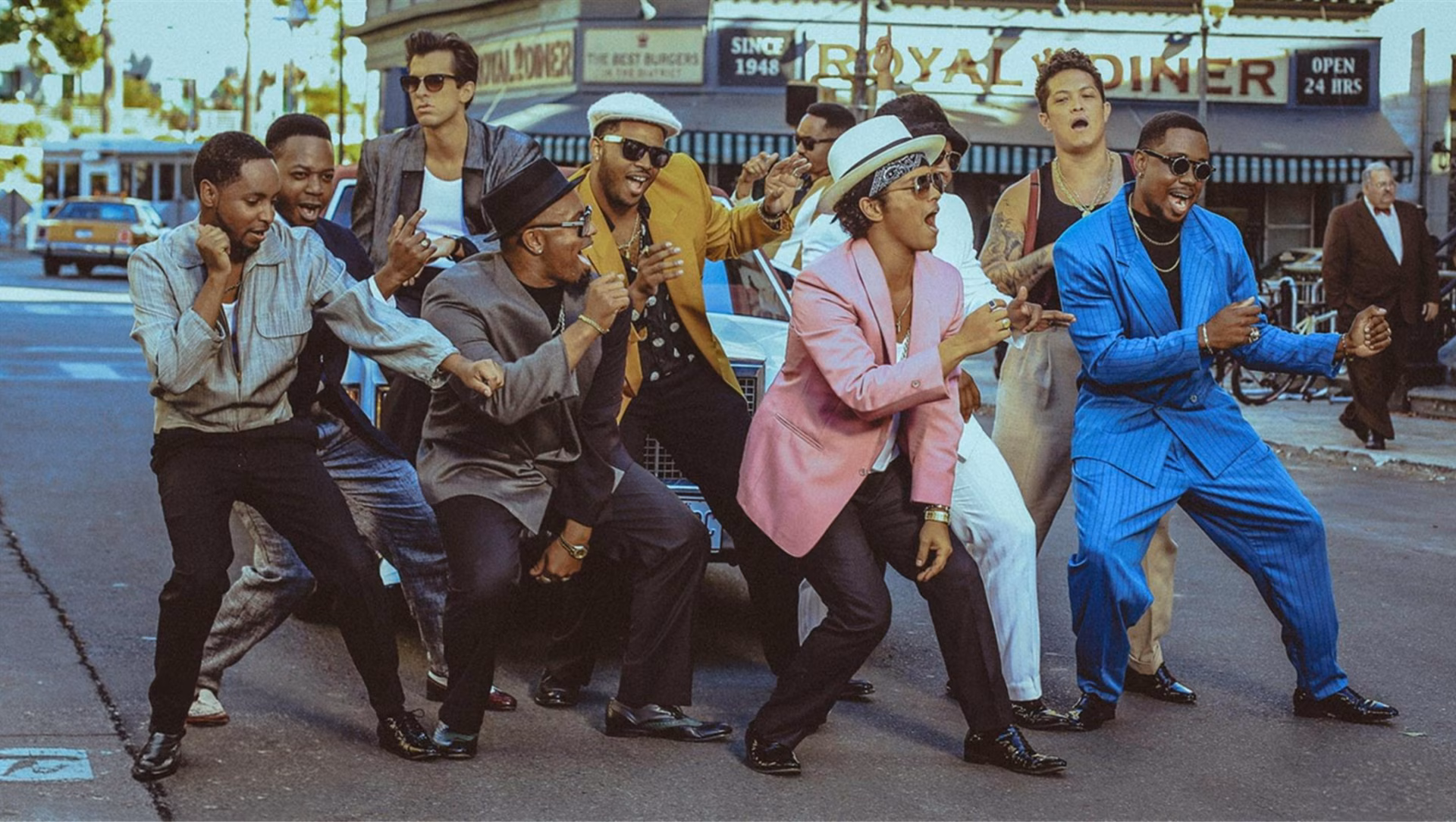 People dancing in a music video, representing English learning through songs
